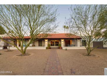 Single story home with red tile roof, walkway, and mature trees at 12211 N 57Th St, Scottsdale, AZ 85254