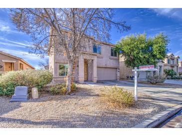 Two-story home with a two-car garage and desert landscaping at 1259 E Canyon Trl, San Tan Valley, AZ 85143