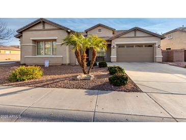 Single-story home with a two-car garage and desert landscaping at 1603 E Zion Way, Chandler, AZ 85249