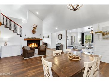 Bright dining room features a rustic wooden table and hardwood floors at 17642 E Hunt Hwy, Queen Creek, AZ 85142