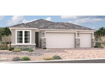 Two-story house with three-car garage and stone accents at 18237 W Hess St, Goodyear, AZ 85338