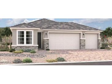 Two-story house with three-car garage and desert landscaping at 18255 W Hess St, Goodyear, AZ 85338