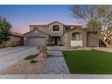 Two-story house with gray exterior, landscaped yard, and a three-car garage at 1918 W Bonanza Ln, Phoenix, AZ 85085