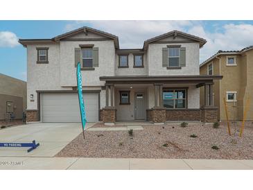 Charming two-story home with stone accents, a two-car garage, and low-maintenance landscaping at 23128 E Watford Dr, Queen Creek, AZ 85142