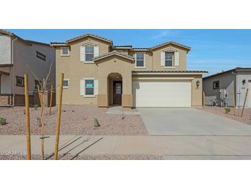 Two-story home with a two-car garage, desert landscaping, and a welcoming front entrance at 23136 E Watford Dr, Queen Creek, AZ 85142