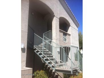 Exterior view of building entrance with stairs and metal railing at 29606 N Tatum Blvd # 216, Cave Creek, AZ 85331