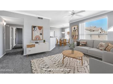 Bright living room showcasing an open floor plan, stylish decor, and ample natural light at 29606 N Tatum Blvd # 216, Cave Creek, AZ 85331