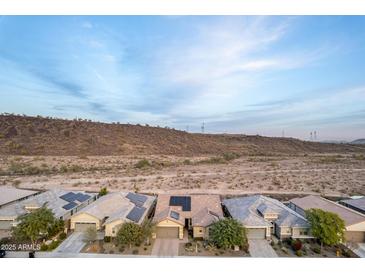 Homes with solar panels and desert landscape at 30255 N 115Th Dr, Peoria, AZ 85383