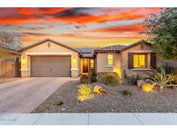 Single-story home with desert landscaping and a two-car garage at 30255 N 115Th Dr, Peoria, AZ 85383