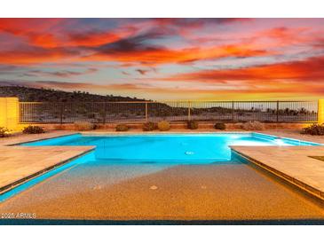 Relaxing pool with light-colored stone decking at 30255 N 115Th Dr, Peoria, AZ 85383