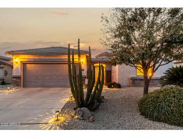 Attractive single-story home with landscaped desert front yard and two-car garage at 30792 N Orange Blossom Cir, San Tan Valley, AZ 85143