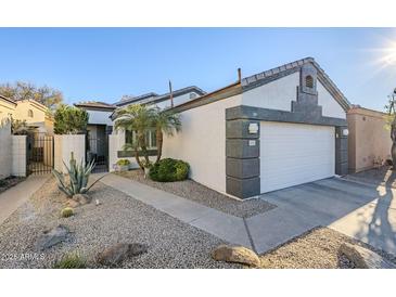 Single-story home with white exterior, gray accents, and landscaped yard at 3324 E Maldonado Dr, Phoenix, AZ 85042