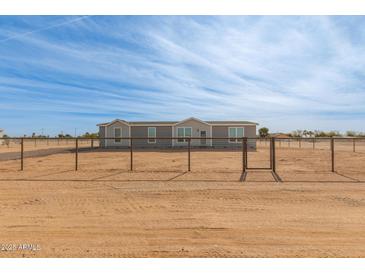 Single-story home with a fenced yard at 36735 W Harrison St, Tonopah, AZ 85354