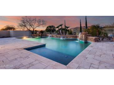 Stunning pool with waterfall feature and spacious tanning area at 3756 E Galvin St, Cave Creek, AZ 85331