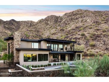 Stunning modern home with stone accents, nestled in the mountains at 8200 N Charles Dr, Paradise Valley, AZ 85253