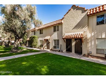 View of three-unit Spanish-style building with lush landscaping at 8241 N Central Ave # 32, Phoenix, AZ 85020