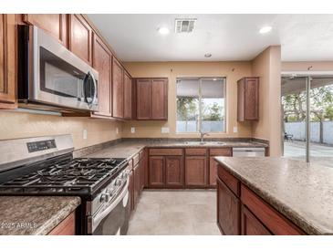 View of kitchen with gas range and stainless steel appliances at 8841 W Cordes Rd, Tolleson, AZ 85353