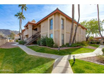 Attractive exterior of a two-story condo with landscaped grounds at 10410 N Cave Creek Rd # 2011, Phoenix, AZ 85020