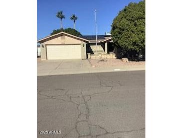 Single story home with attached two car garage and mature landscaping at 1724 W 15Th Ave, Apache Junction, AZ 85120