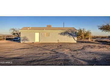 Rear view of a single-story house with a spacious yard at 1814 S 363Rd Ave, Tonopah, AZ 85354