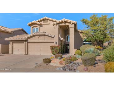 Two-story house with desert landscaping and a two-car garage at 19034 N 94Th Way, Scottsdale, AZ 85255