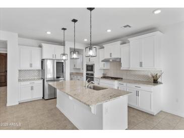 Modern kitchen with stainless steel appliances and granite countertops at 19961 W Heatherbrae Dr, Litchfield Park, AZ 85340