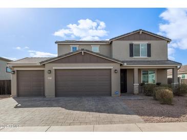 Two-story house with brown garage doors and landscaping at 2071 E Piedmont Pl, Casa Grande, AZ 85122