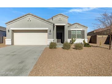 One-story house with gray exterior, two-car garage, and desert landscaping at 29402 W Mitchell Ave, Buckeye, AZ 85396