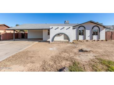 White single story home with arched entryway and carport at 3744 W Malapai Dr, Phoenix, AZ 85051