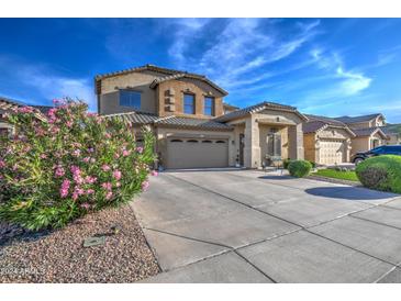 Two-story house with a three-car garage and landscaped front yard at 46107 W Morning View Ln, Maricopa, AZ 85139