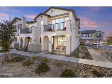 Two-story townhome with balcony, attractive landscaping, and inviting front porch at 4717 S Ferric --, Mesa, AZ 85212