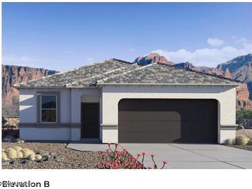 Single-story home with a two-car garage and desert landscaping at 5501 E Rock Bush Ln, San Tan Valley, AZ 85140