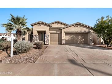 Two-story house with tan exterior, two-car garage, and landscaped front yard at 6229 S Moccasin Trl, Gilbert, AZ 85298