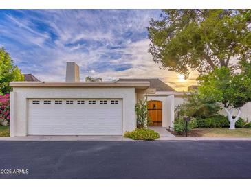 Single-story home with attached garage and landscaped front yard at 7028 N Barbados Pl, Phoenix, AZ 85021