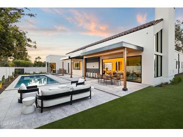 Stunning backyard with a pool, patio, and outdoor seating, perfect for entertaining and relaxation at 8255 E Morgan Trl, Scottsdale, AZ 85258