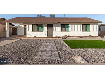 White house with brown roof, landscaped yard, and walkway at 874 E Tyson St, Chandler, AZ 85225