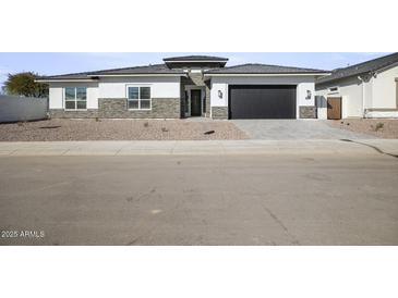 Modern single-story home with stone accents and a two-car garage at 10229 N 177Th Dr, Waddell, AZ 85355