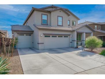 Two-story house with gray siding, two-car garage, and landscaped yard at 21269 W Haven Dr, Buckeye, AZ 85396