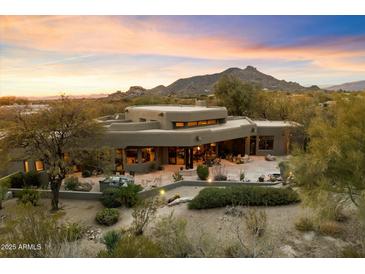 Luxury home with expansive backyard and mountain views at sunset at 34587 N Ironwood Rd, Scottsdale, AZ 85266