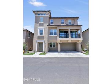 Three-story home with attached two-car garage and balcony at 4284 E Erie St, Gilbert, AZ 85295