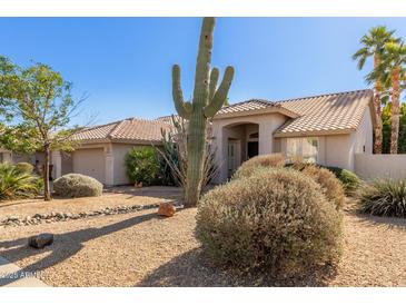 One-story house with desert landscaping, featuring a terracotta tile roof and neutral color scheme at 13345 W Cypress St, Goodyear, AZ 85395