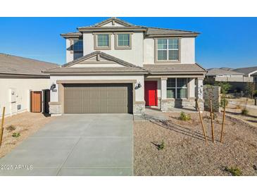 Two-story house with red door, gray garage door, and landscaping at 17724 W Sanna St, Waddell, AZ 85355