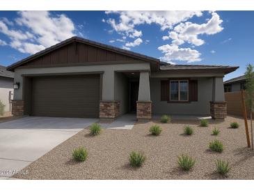 Charming single-story home featuring a two-car garage and low-maintenance desert landscaping at 22645 W Irma Ln, Surprise, AZ 85387