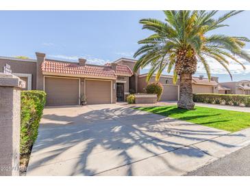 Two-car garage, attractive landscaping, and a welcoming entryway at 25227 S Mohawk Dr, Sun Lakes, AZ 85248