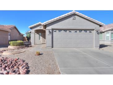 Single-story home with a two-car garage and well-maintained landscaping at 498 N Santiago Trl, Casa Grande, AZ 85194