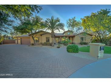 Beautiful one-story home with a large driveway and mature landscaping at 6502 N 81St Pl, Scottsdale, AZ 85250