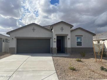 One-story home with gray garage door and desert landscaping at 1216 S Mullberry St, Florence, AZ 85132