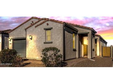 Stunning stucco home with a Spanish-style tile roof and landscaped yard at 13648 W Desert Glen Dr, Sun City West, AZ 85375