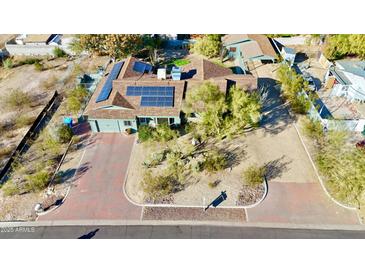 Charming single-story home with solar panels, desert landscaping, and a brick driveway at 1414 E Shangri La Rd, Phoenix, AZ 85020