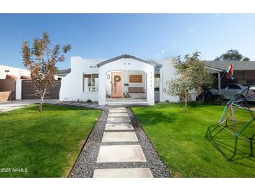 Cute bungalow with a freshly landscaped lawn and walkway at 2329 N Evergreen St, Phoenix, AZ 85006